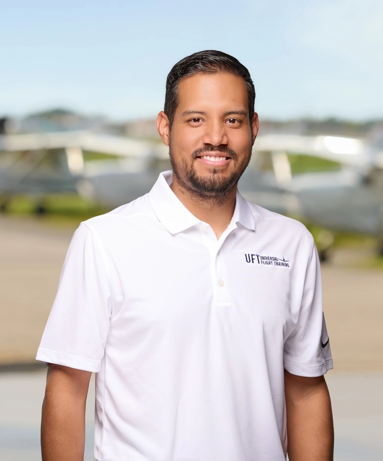 Technician inspecting aircraft engine inside hangar